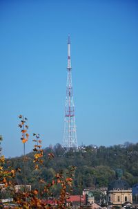 Low angle view of communications tower against clear blue sky