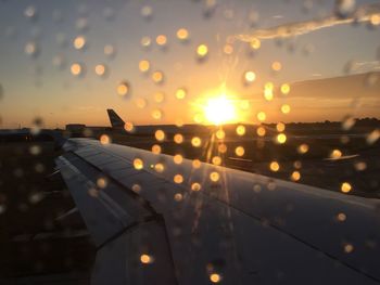 Airplane against sky during sunset