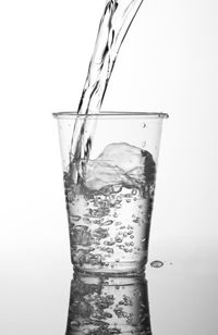 Close-up of water splashing against white background