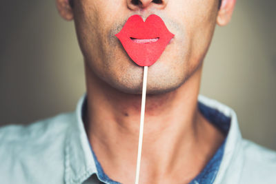 Close-up of man with kissing prop