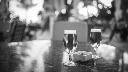 Close-up of beer in glasses on table at outdoor restaurant