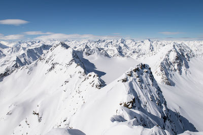 Scenic view of snow covered mountains against sky