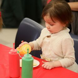 Girl having food while sitting at table