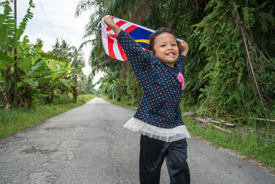 Full length of girl standing on road