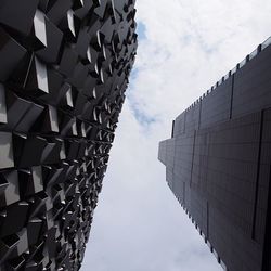 Low angle view of building against cloudy sky