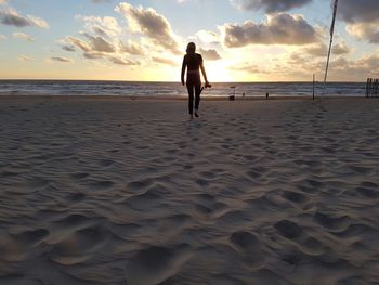 Scenic view of beach at sunset