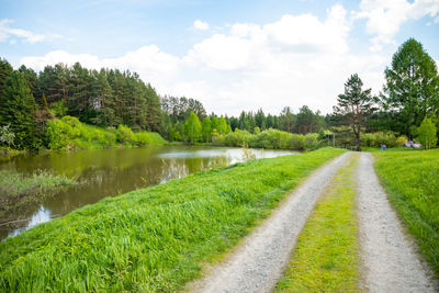 Scenic view of lake by trees against sky