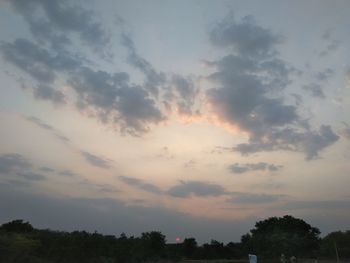 Low angle view of silhouette trees against sky at sunset