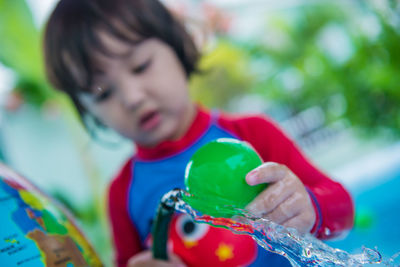 Portrait of cute asian boy playing with water