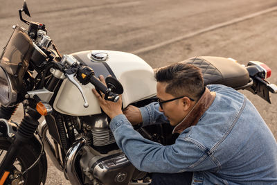 On the route to a summer vacation on a motorcycle, biker guy on an asphalt highway, a crouching .