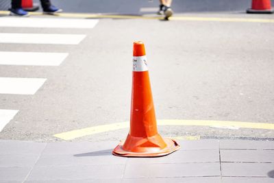 Red crossing sign on street in city