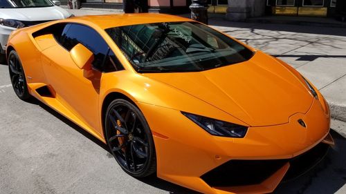 Yellow car parked on road in city