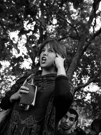 Low angle view of woman against tree