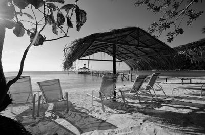 View of chairs on beach against sky