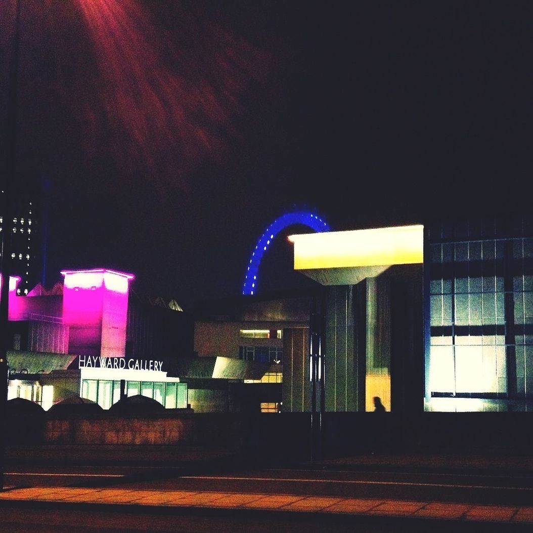 illuminated, night, architecture, built structure, building exterior, communication, text, no people, city, western script, blue, outdoors, lighting equipment, empty, street, absence, road, metal, sky, light - natural phenomenon