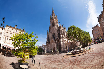 Panoramic view of trees and buildings against sky