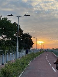 Street against sky during sunset