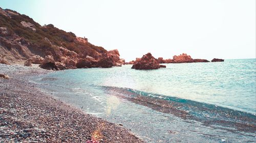 Scenic view of beach against clear sky