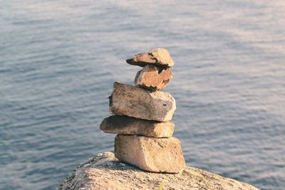 Close-up of stack on groyne against sea