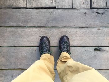 Low section of man standing on tiled floor