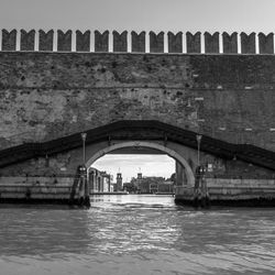 Bridge over river with city in background