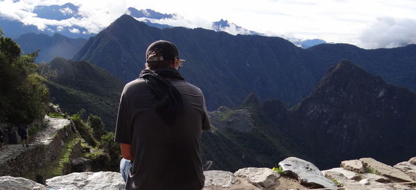 Rear view of male tourist  looking at machu picchu pichu mountains