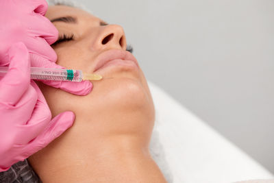 Midsection of woman holding thermometer