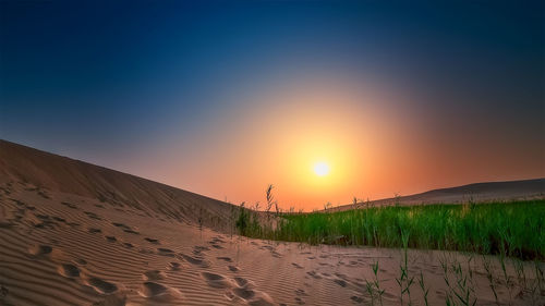 Scenic view of desert against sky during sunset