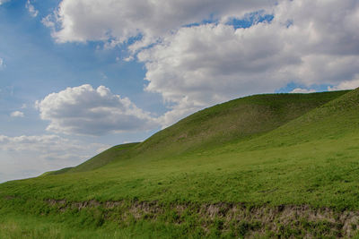 Scenic view of green landscape against sky