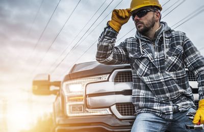 Worker standing by car