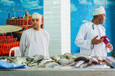 Man and fish at market stall