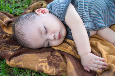Baby boy sleeping on shawl