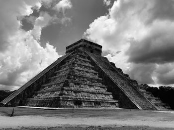 Low angle view of historical building against cloudy sky