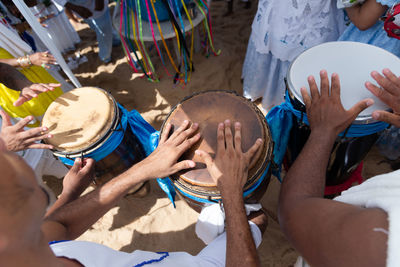 Percussionist hands playing atabaque.