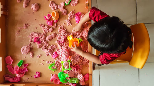 High angle view of baby boy playing with toys on table at home