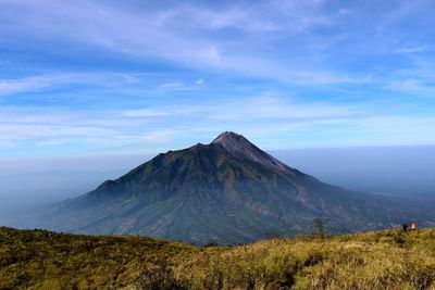 Scenic view of mountain range against blue sky