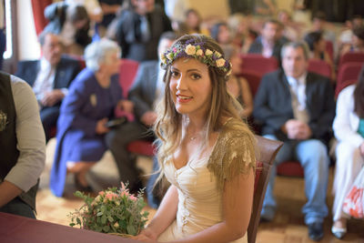 Portrait of bride sitting at church during wedding ceremony