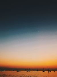 Scenic view of beach against clear sky during sunset