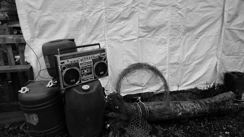 Old radio on can against tarpaulin