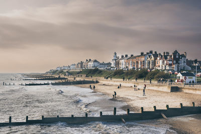 View of town by sea against sky