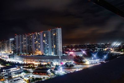 High angle view of illuminated buildings in city at night