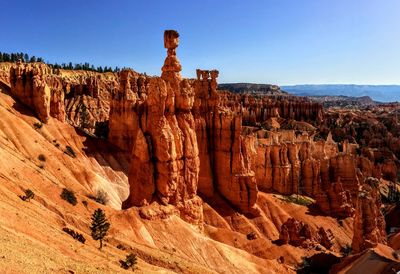 Hoodoo and pine trees in bryce canyon national park in utah blue partly cloudy skies.