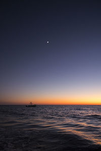 Scenic view of sea against clear sky at night