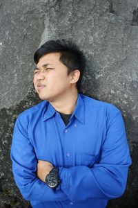 Portrait of young man sitting outdoors