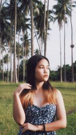 Portrait of young woman sitting on field