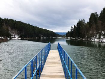 Pier over lake against sky