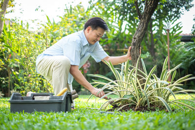 Full length of man on grass against trees