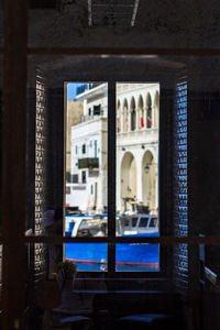 Buildings seen through window of old building