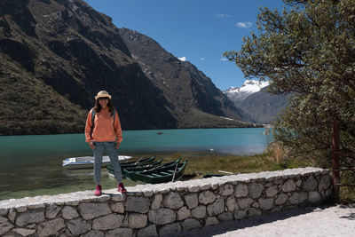 Rear view of woman standing against mountain