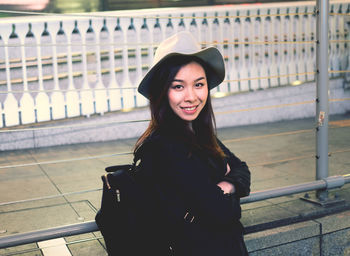 Portrait of a smiling young woman standing outdoors